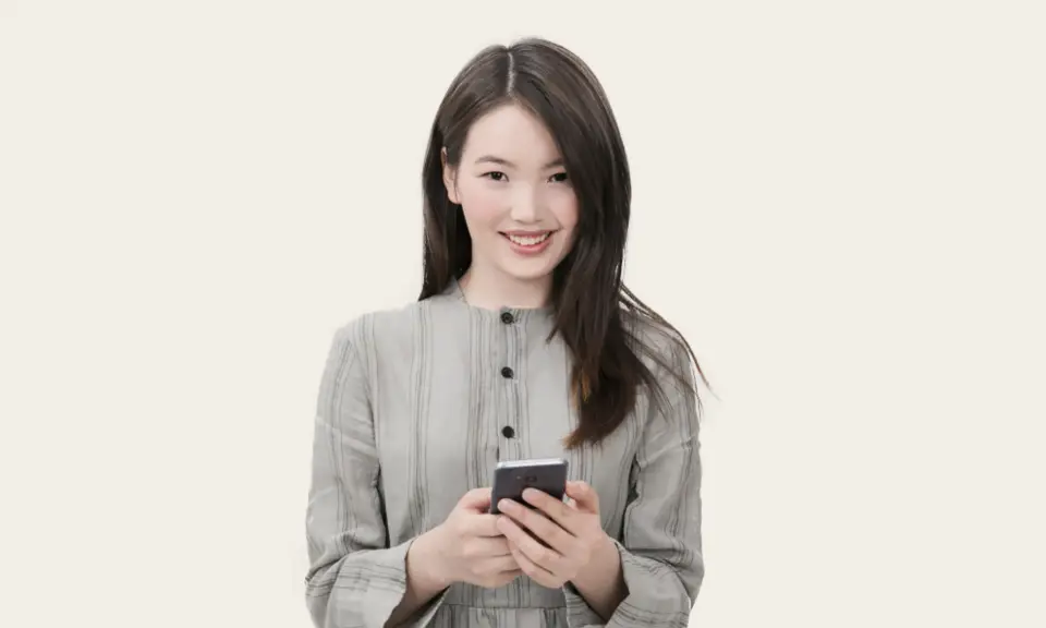 Smiling player holding a smartphone, ready to pay by e-wallet